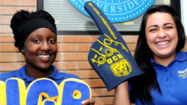 students at a game students with a foam finger