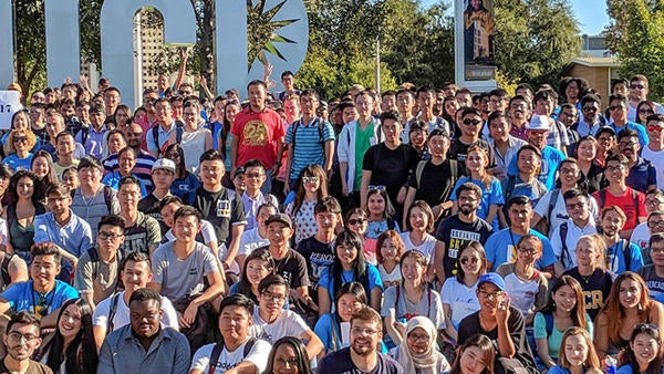 International students group in front of UCR sign International students group in front of UCR sign