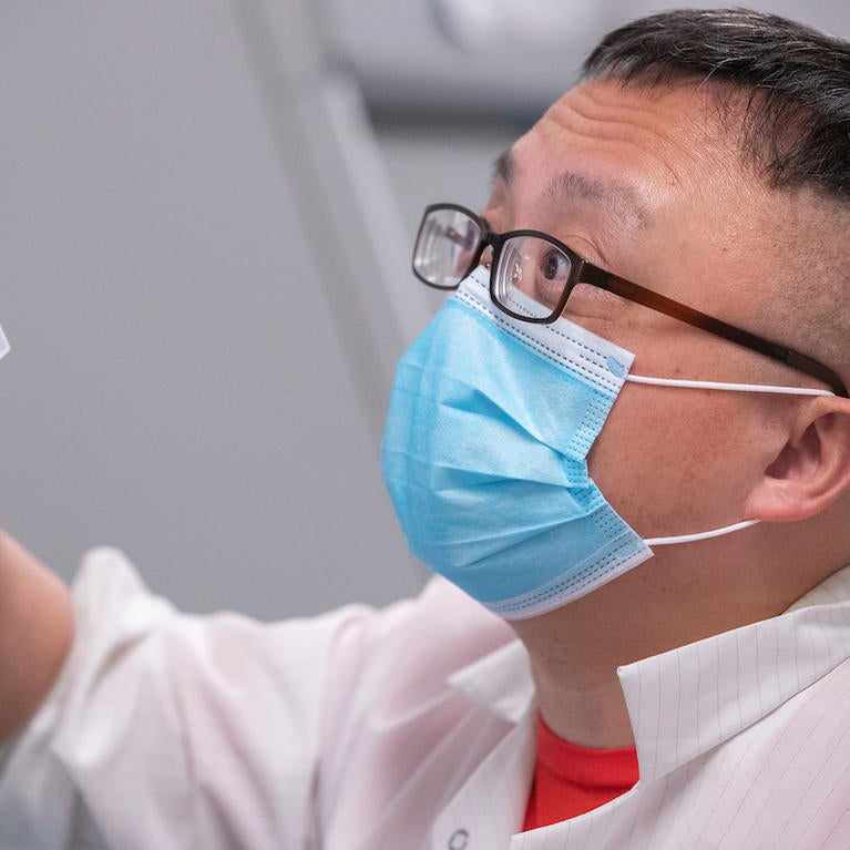 Assistant Professor Rong Hai prepares equipment in the COVID-19 testing lab (UCR/Stan Lim)