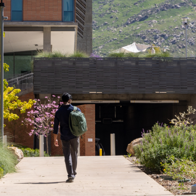CNAS student walking towards academic building