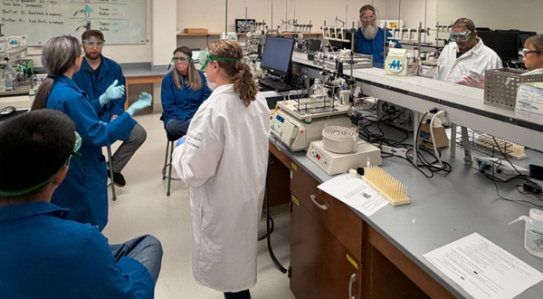 Dr. Stephanie Dingwall with local science teachers in the biochemistry lab