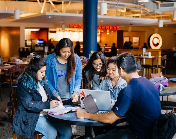 Students sitting around a table in the HUB