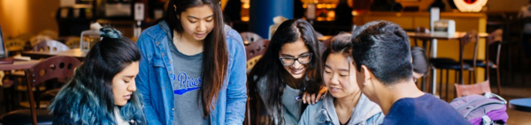 Students sitting at tables in the HUB