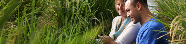 CNAS student with a professor in a campus greenhouse