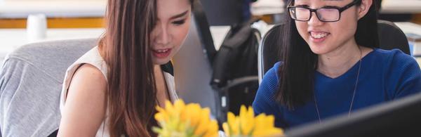 women looking at laptop and smiling