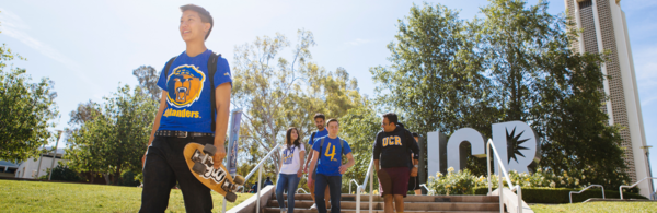 UCR students walking past belltower