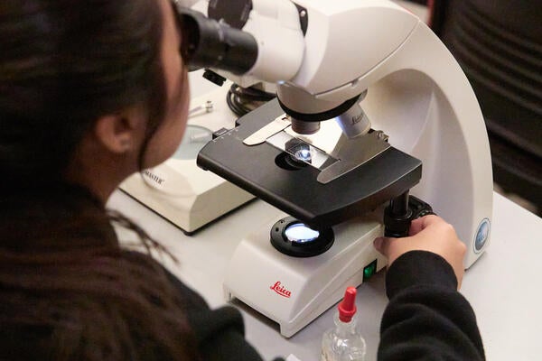 Student with a microscope