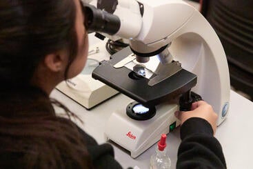 UCR student with microscope