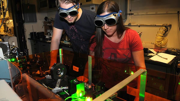 (c) UCR/CNAS - students looking at lasers with goggles on