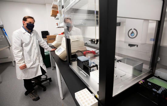 Matthew Collin, genomics core manager, tests equipment in UC Riverside’s COVID-19 testing laboratory 